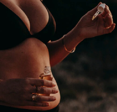 woman holding skin and scar oil