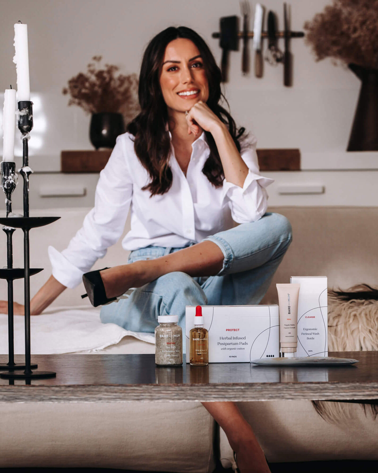 woman sitting in front of products