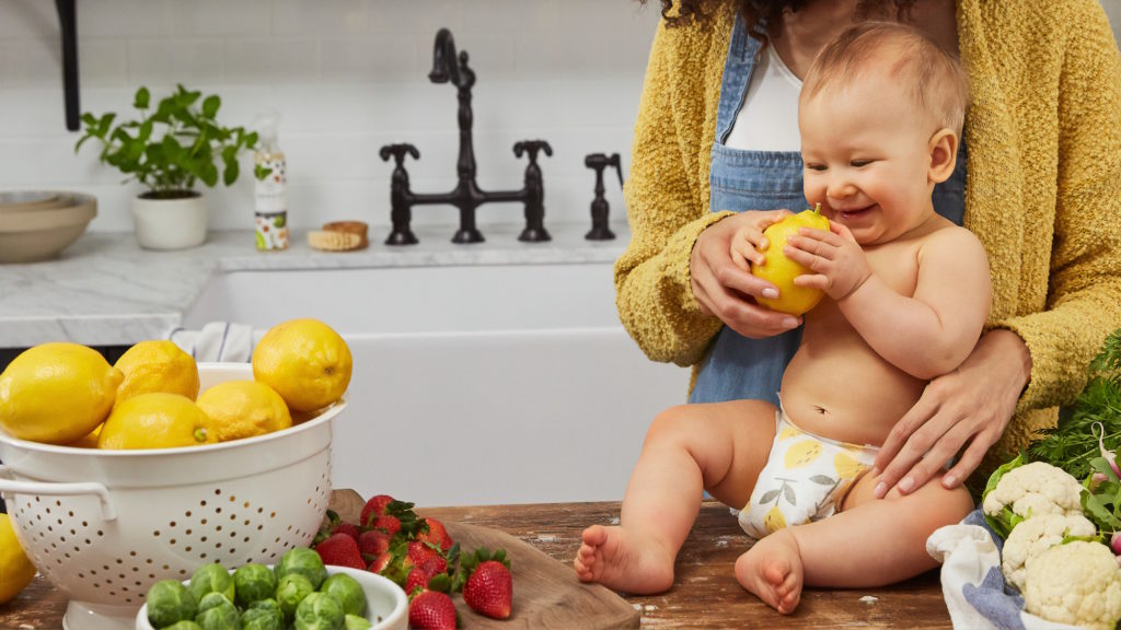 baby holding lemon