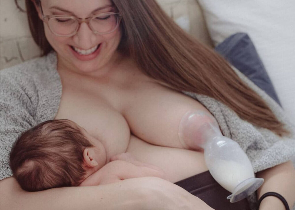 woman breastfeeding while pumping