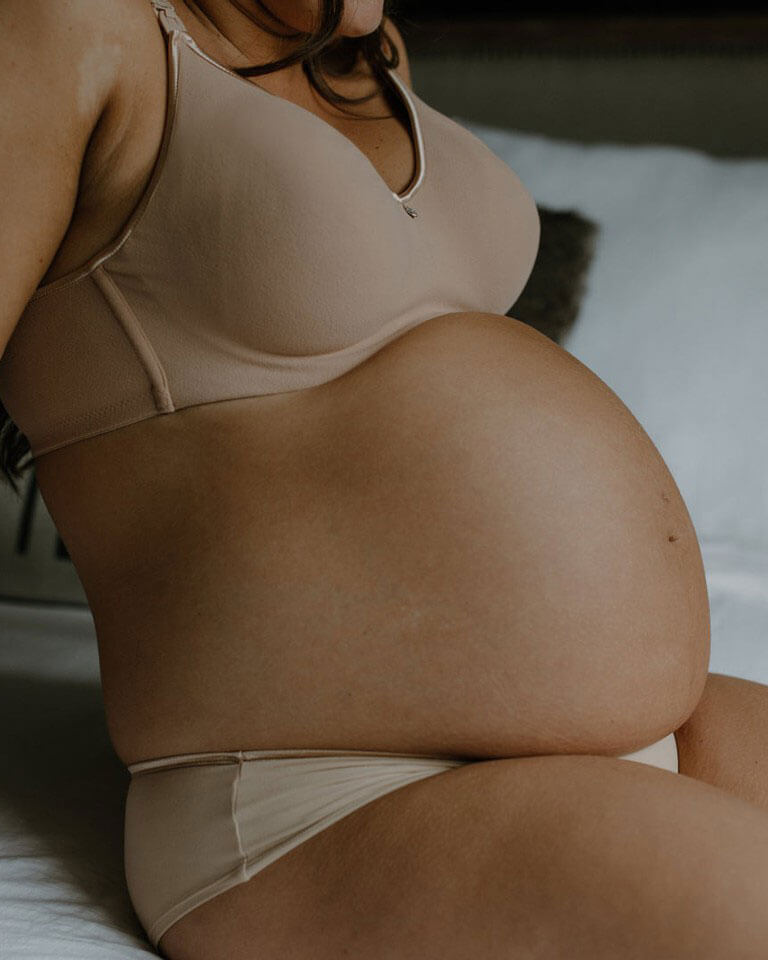 pregnant woman wearing beige croissant nursing bra