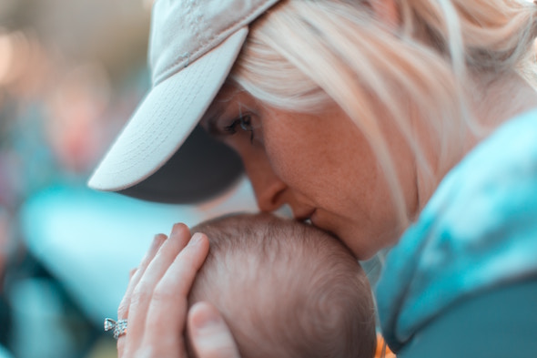 mom kissing baby