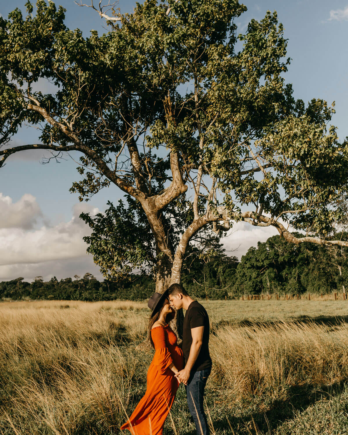 couple facing each other under the tree