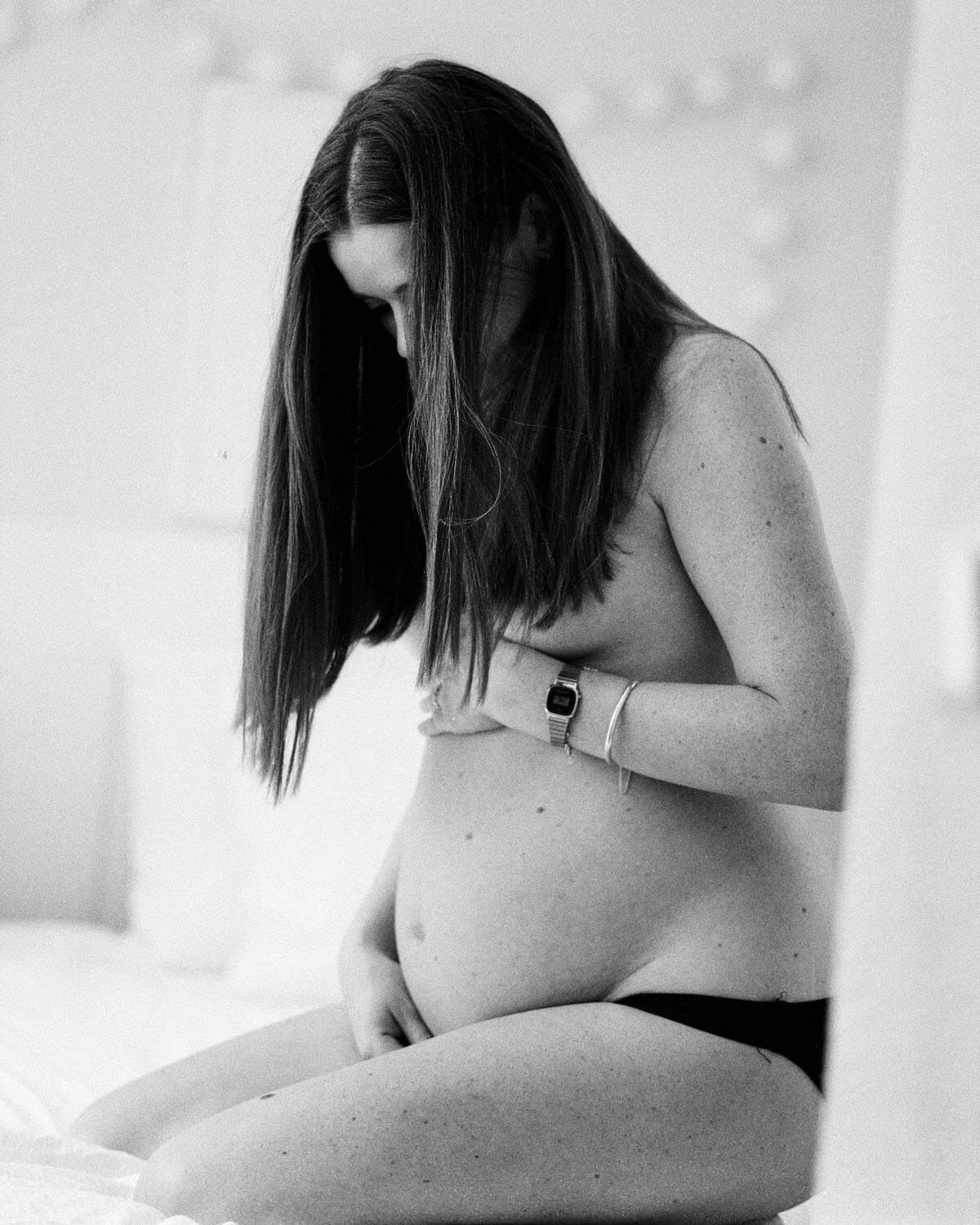 pregnant woman sitting behind the curtain