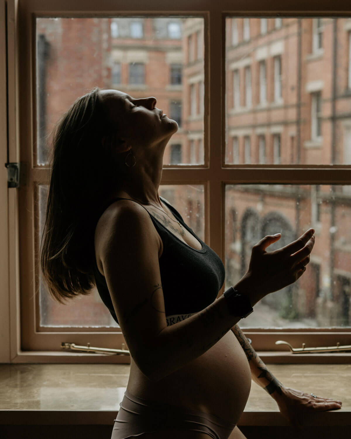 pregnant woman in front of the window