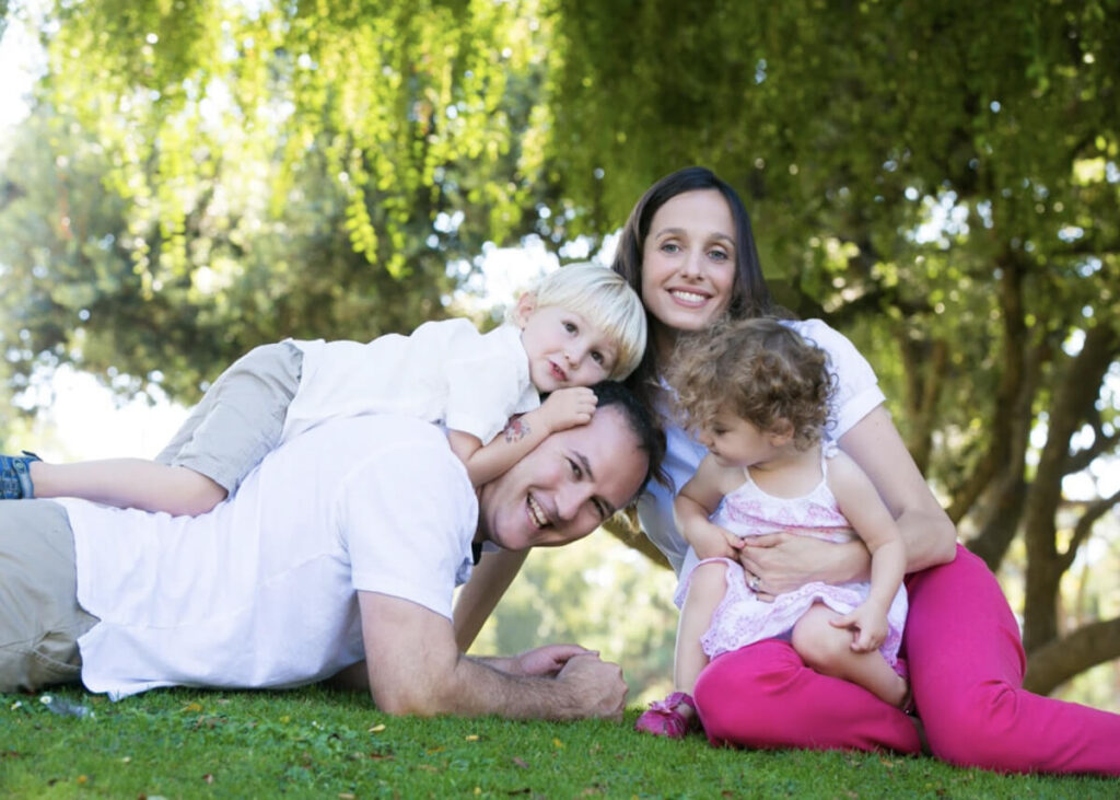 family sitting under the tree