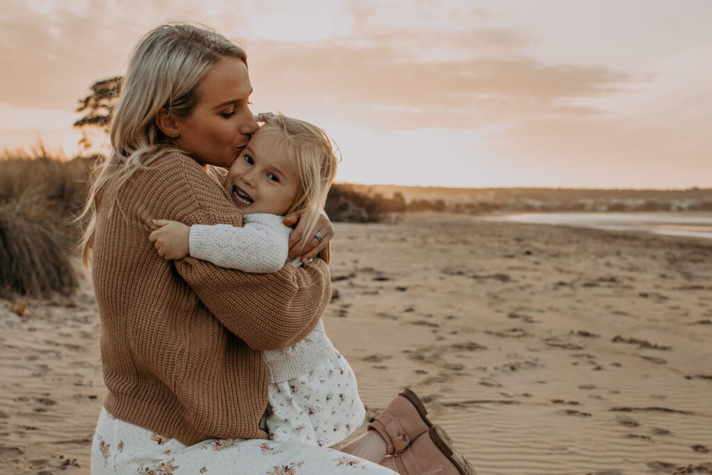 mother and daughter hugging in the field