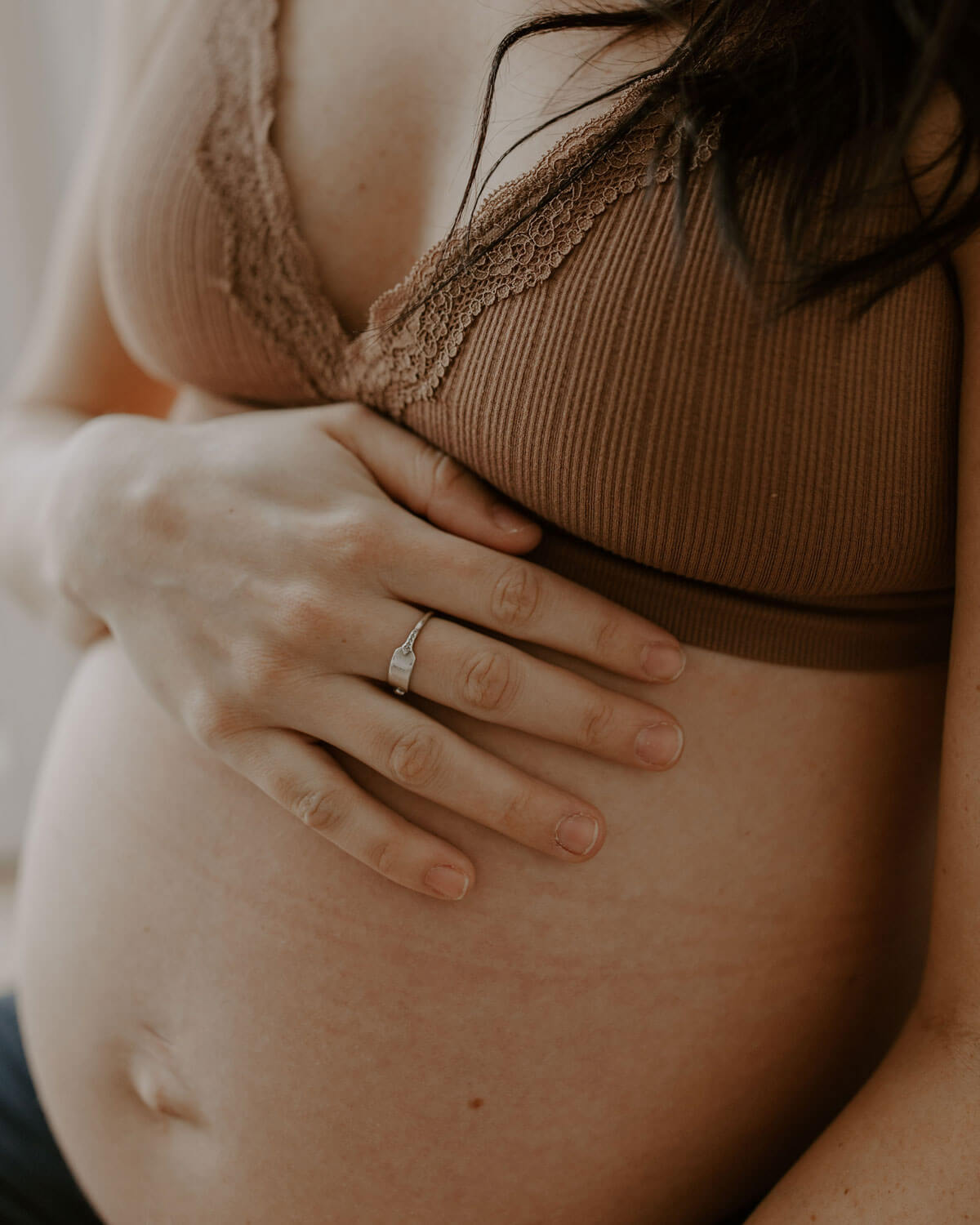 pregnant woman wearing tutti frutti nursing bra