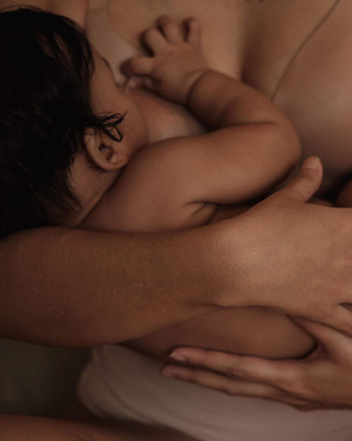baby sleeping in fathers shoulder