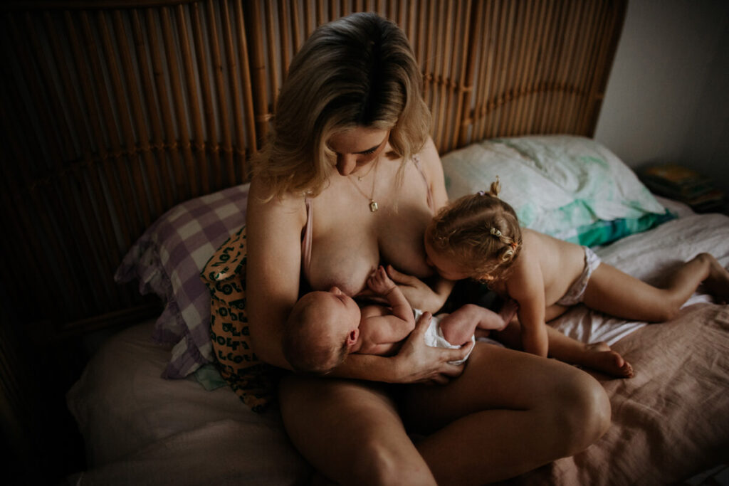 woman breastfeeding children