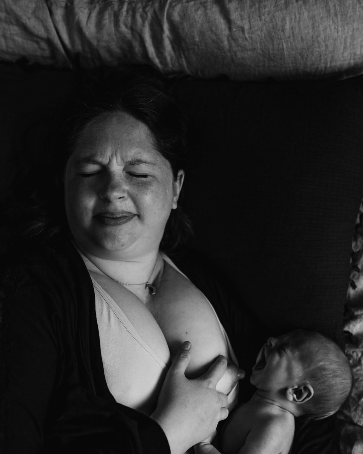 woman in pain breastfeeding