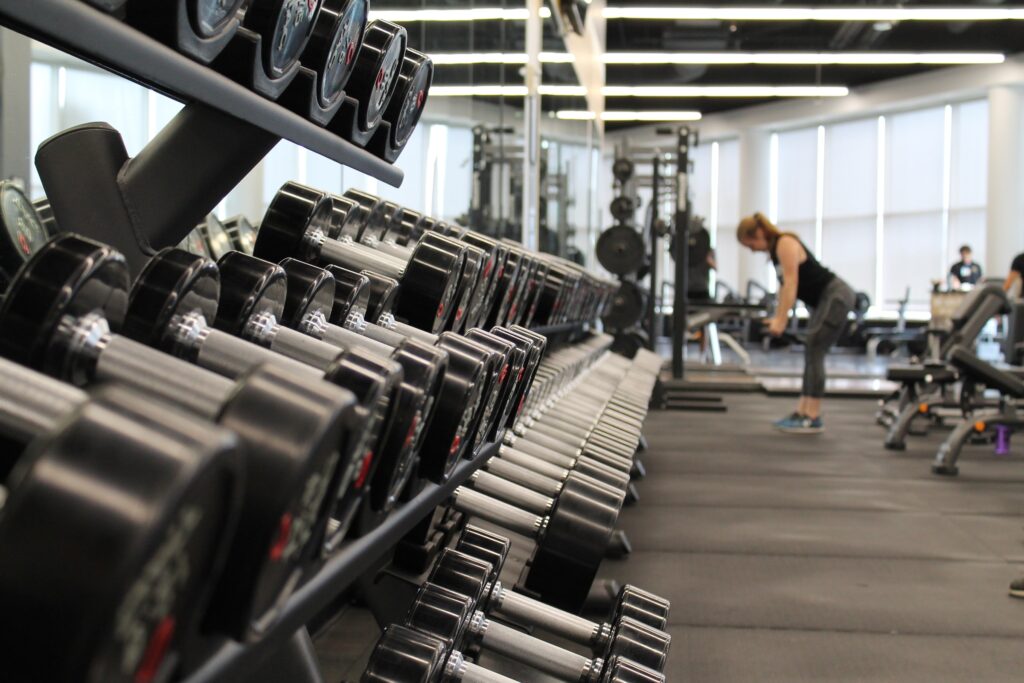 woman surrounded by exercise equipment