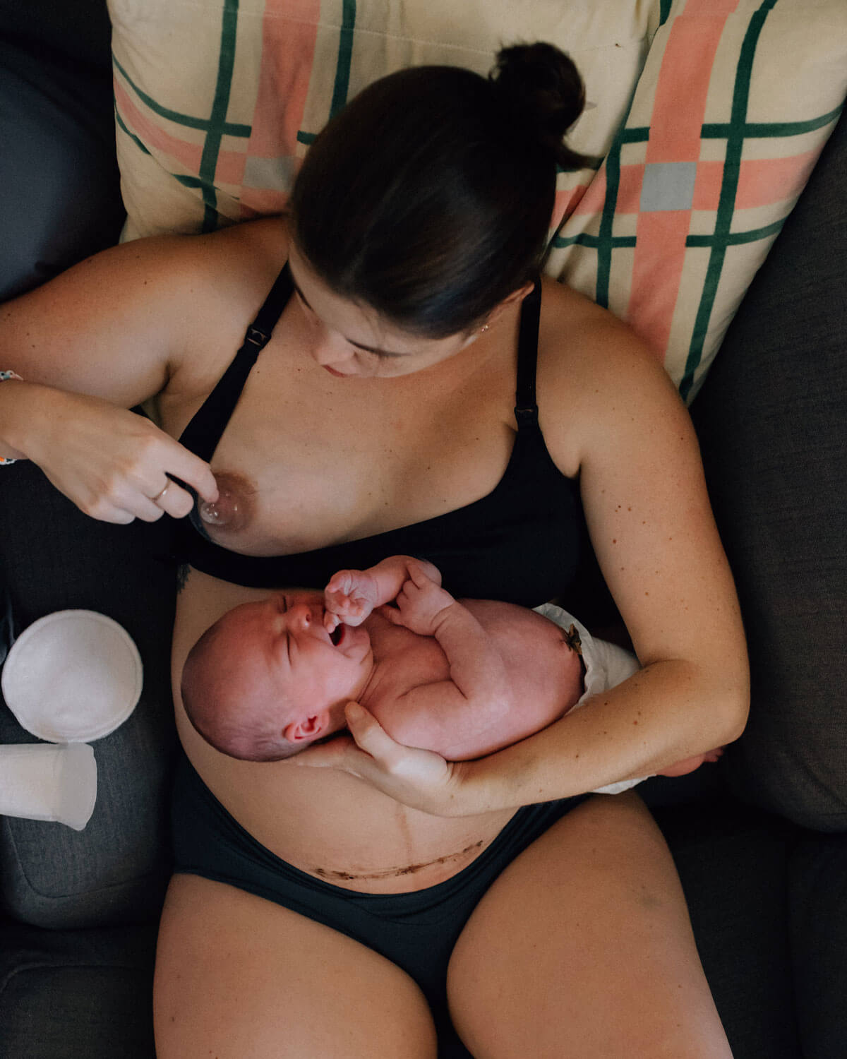 woman breastfeeding after c-section with nipple shield