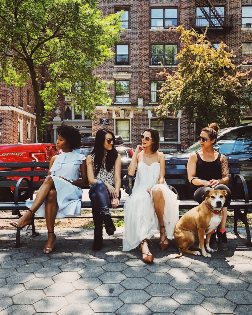 women sitting on black chair